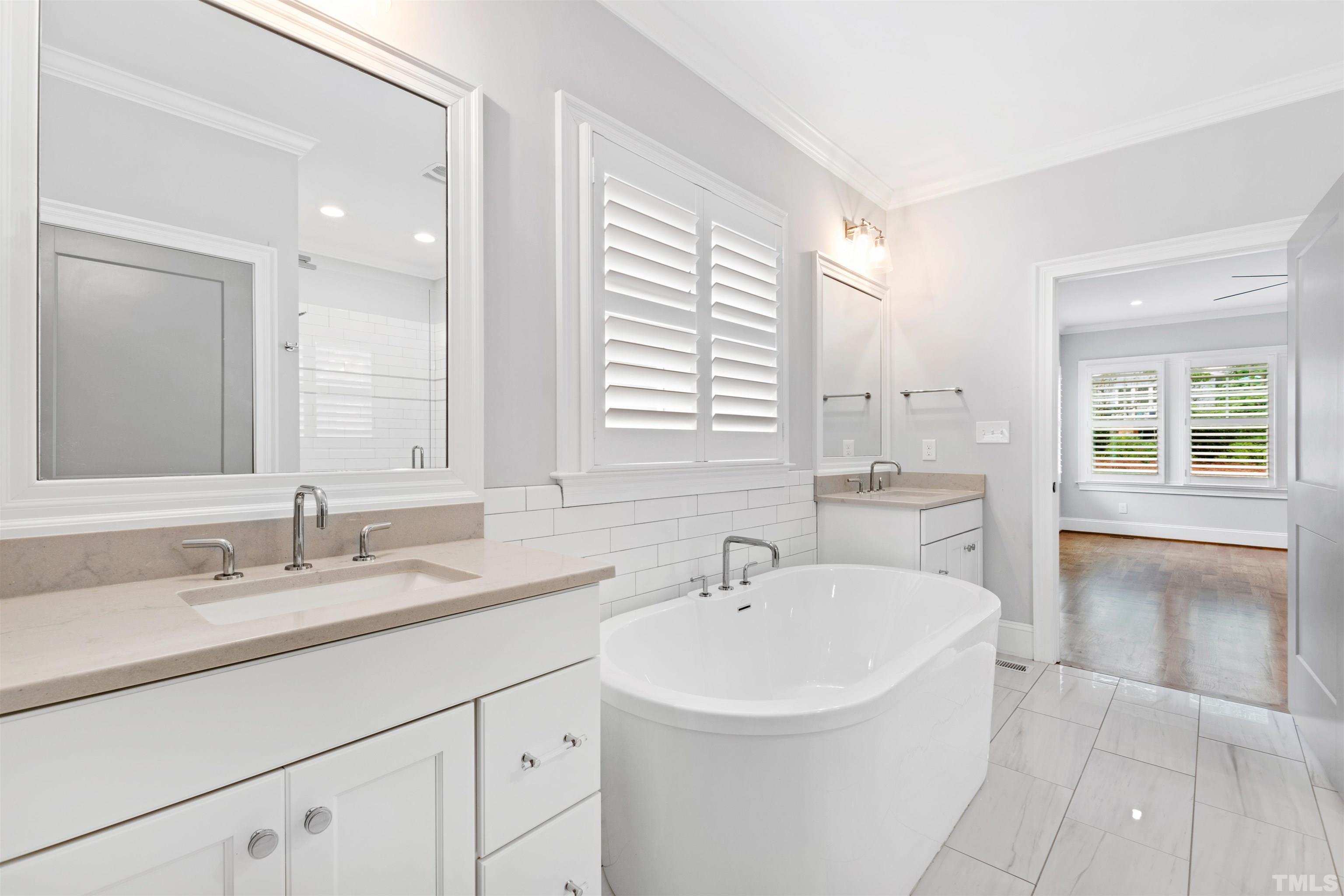 401 Latimer Road Raleigh, NC 27609 - Photo 15 of 45 a bathroom with a sink double vanity and a tub