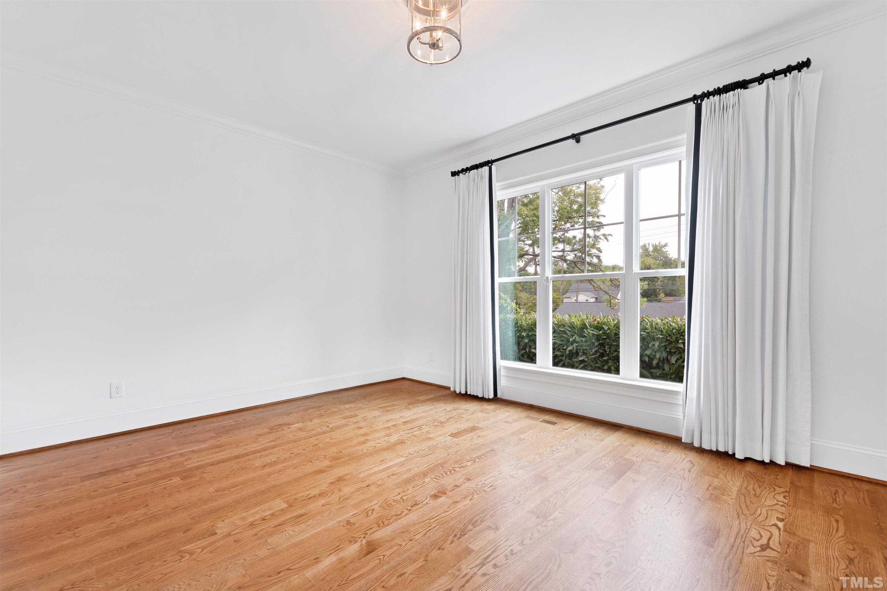 401 Latimer Road Raleigh, NC 27609 - Photo 26 of 45 an empty room with wooden floor and windows