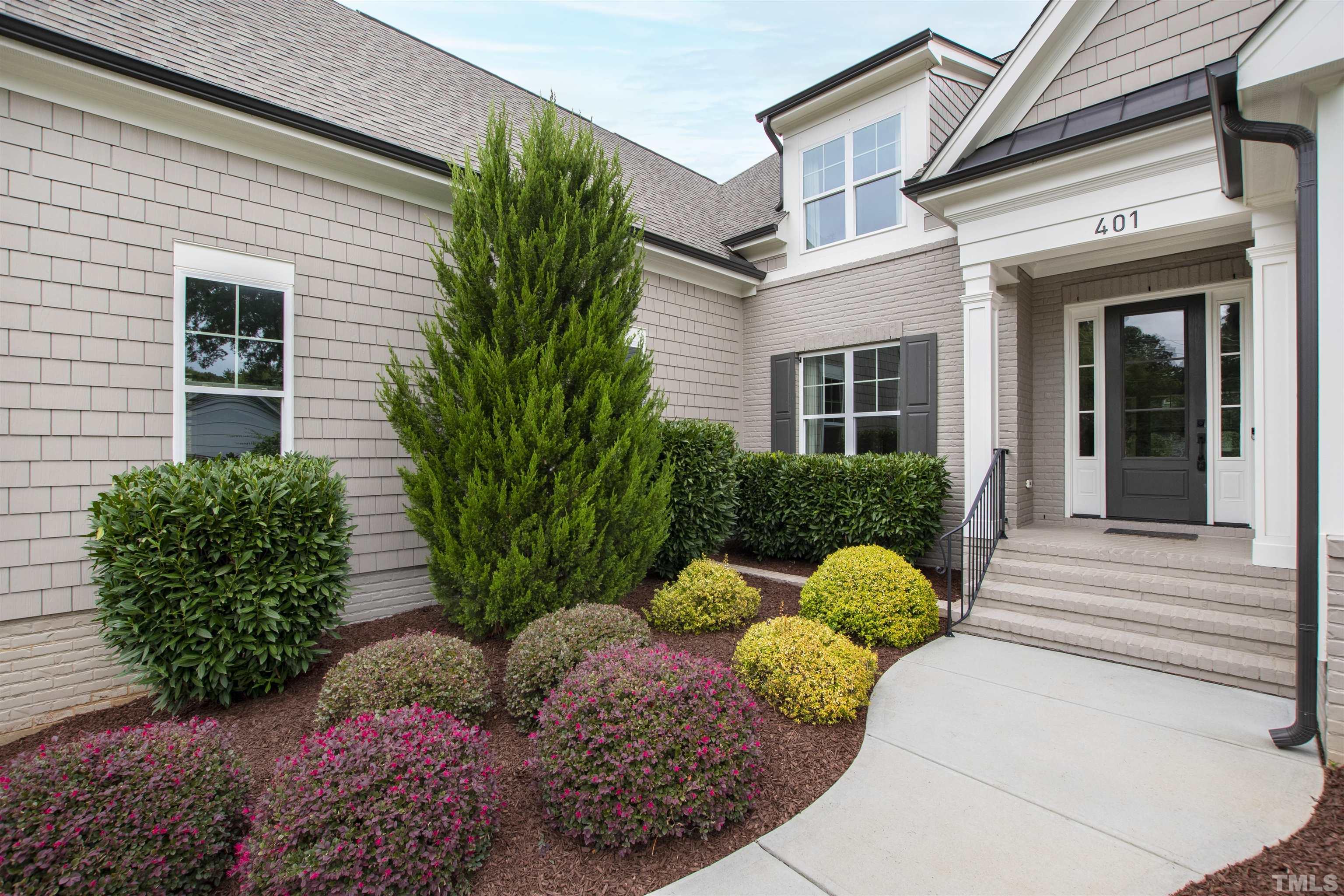 401 Latimer Road Raleigh, NC 27609 - Photo 3 of 45 a front view of a house with a yard and fountain