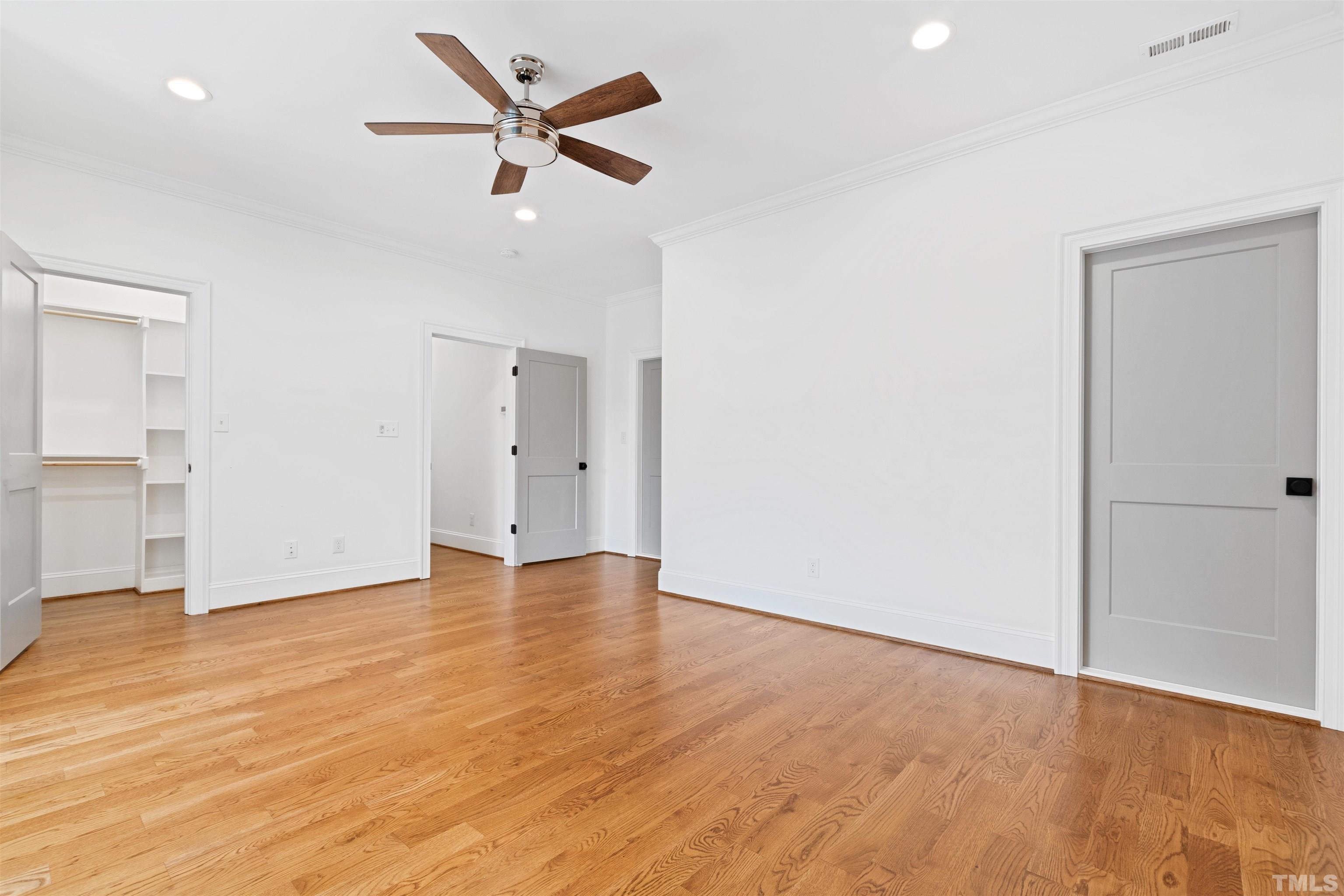 401 Latimer Road Raleigh, NC 27609 - Photo 33 of 45 an empty room with wooden floor and ceiling fan