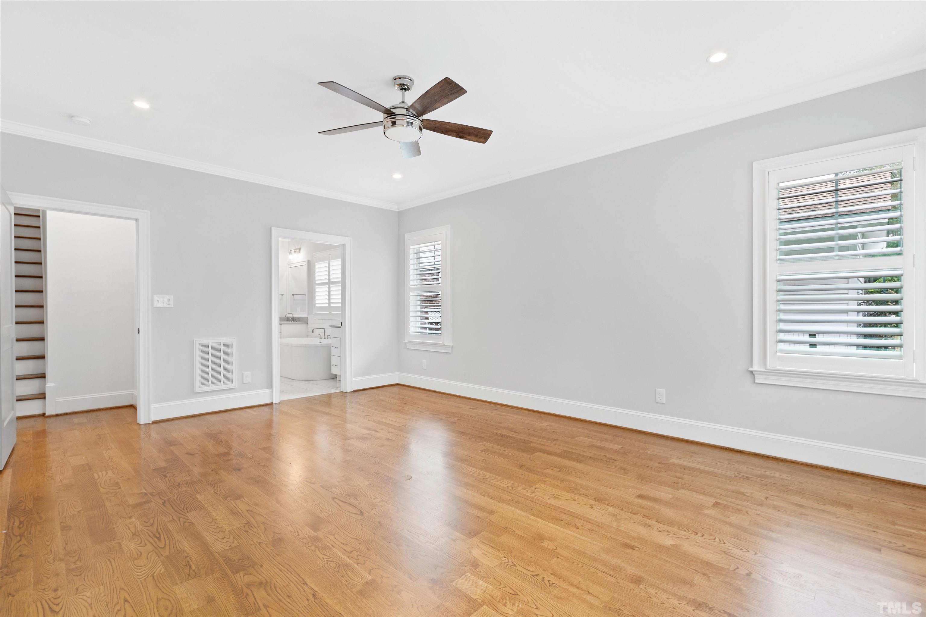 401 Latimer Road Raleigh, NC 27609 - Photo 39 of 45 an empty room with wooden floor fan and windows