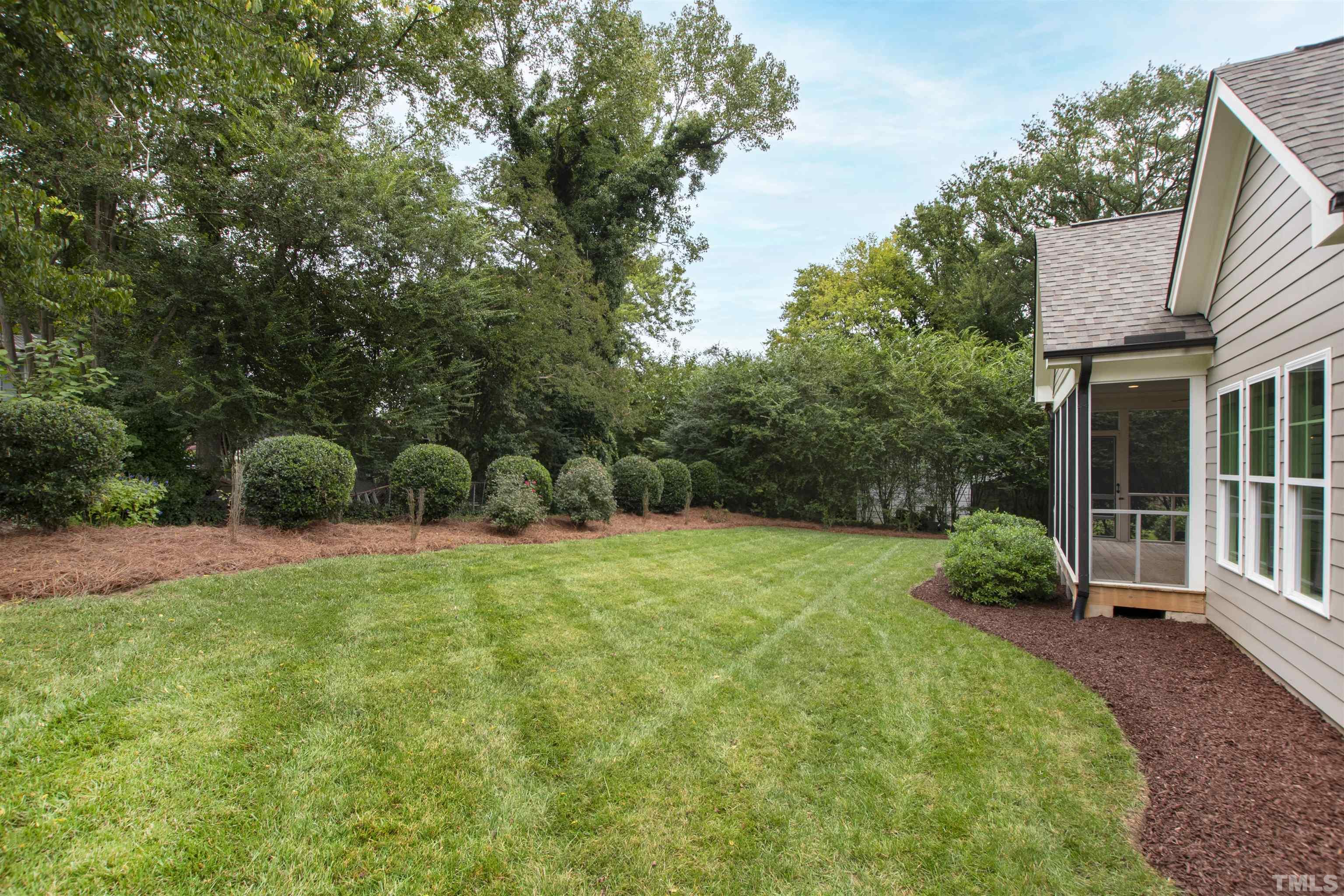 401 Latimer Road Raleigh, NC 27609 - Photo 42 of 45 a backyard of a house with plants and outdoor seating