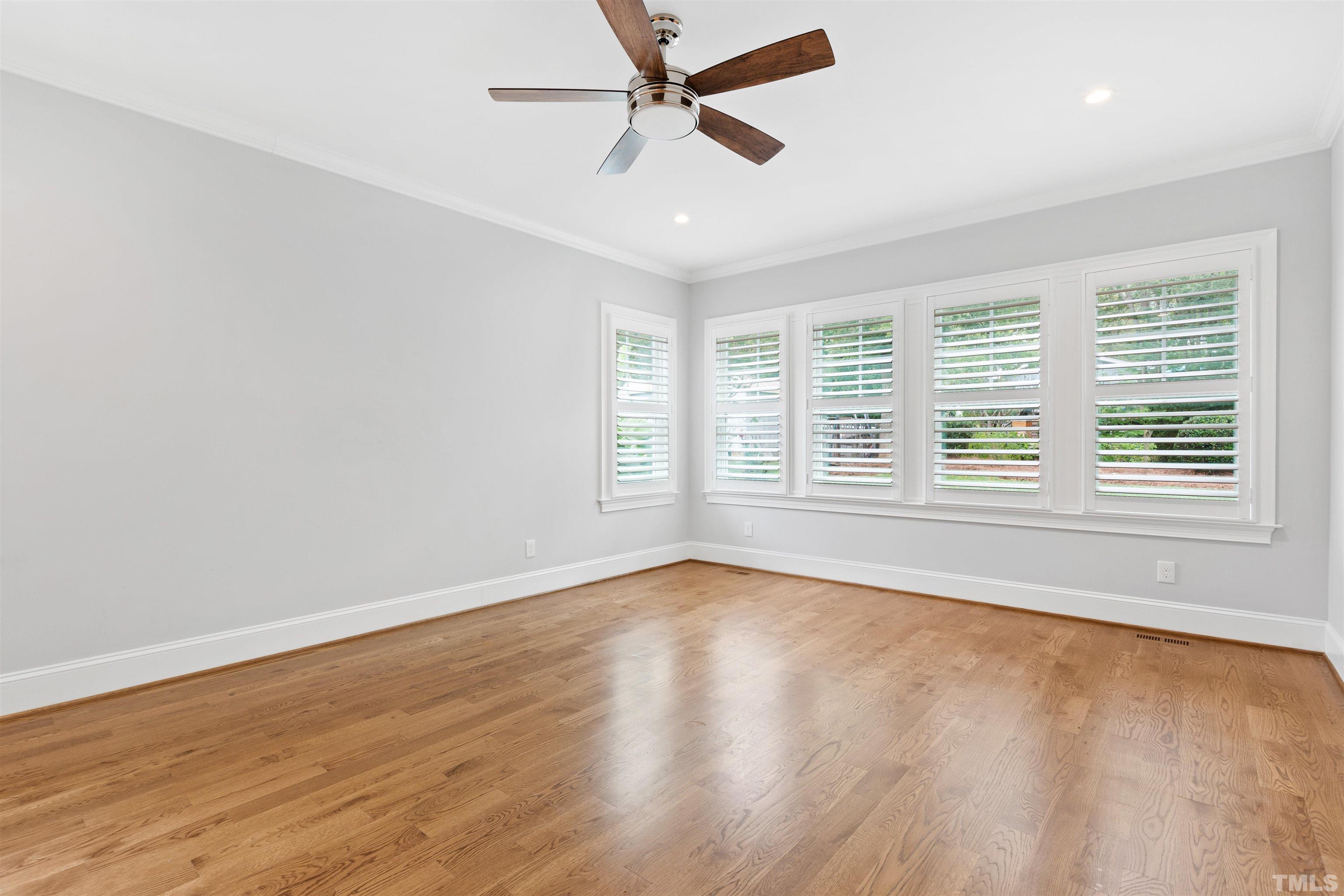 401 Latimer Road Raleigh, NC 27609 - Photo 43 of 45 an empty room with wooden floor and windows