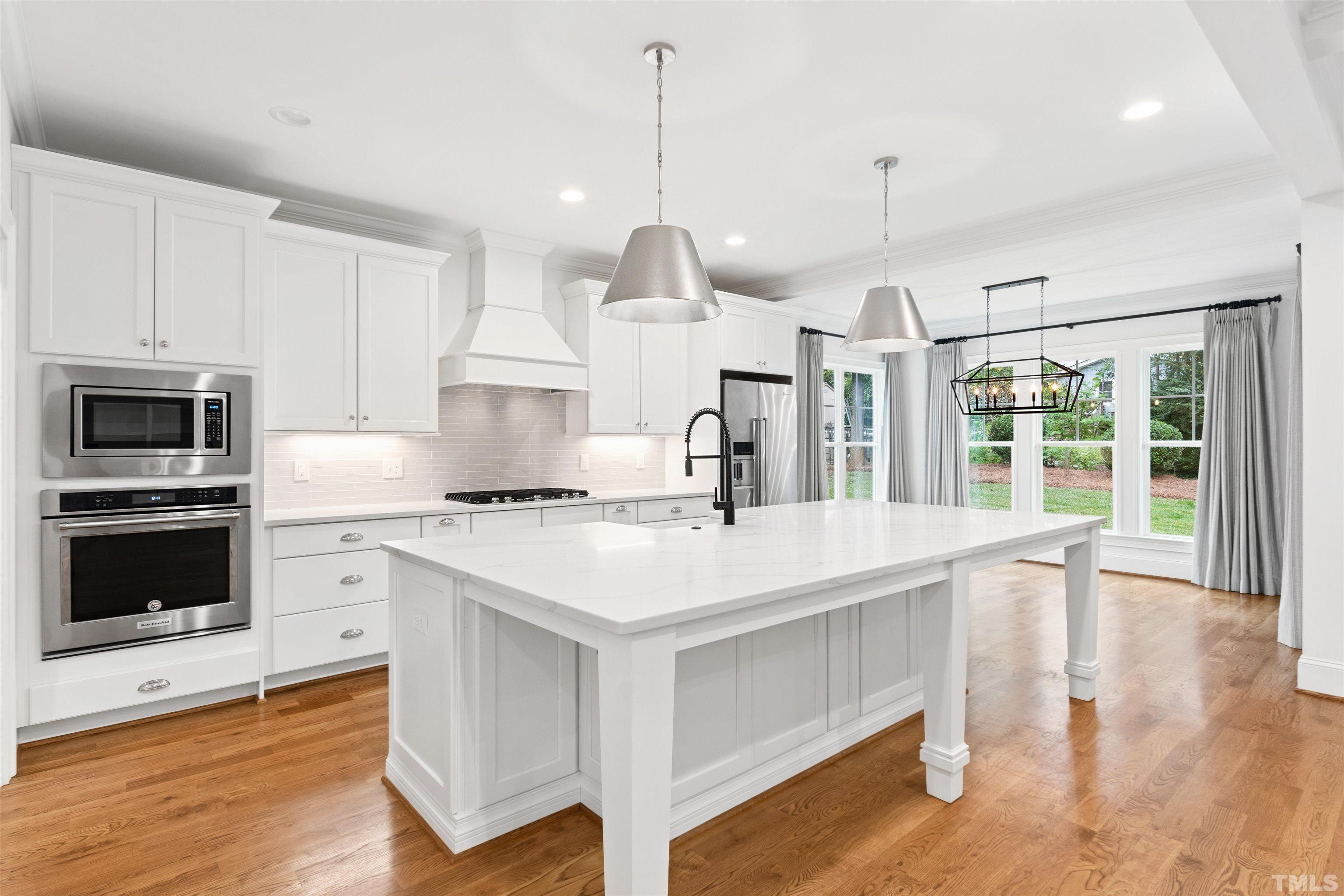 401 Latimer Road Raleigh, NC 27609 - Photo 5 of 45 a kitchen with a stove a sink and a refrigerator