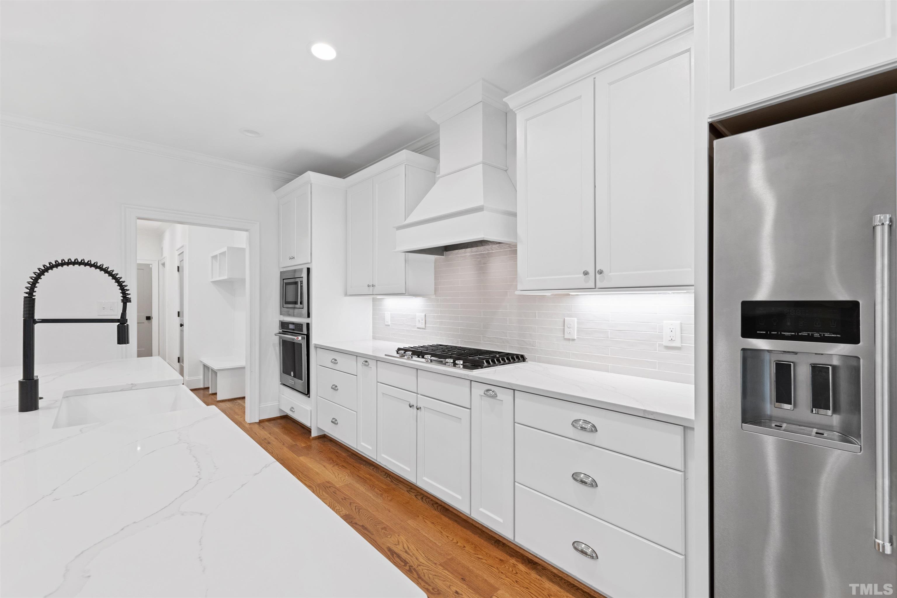 401 Latimer Road Raleigh, NC 27609 - Photo 6 of 45 a kitchen with granite countertop a stove a sink and a refrigerator