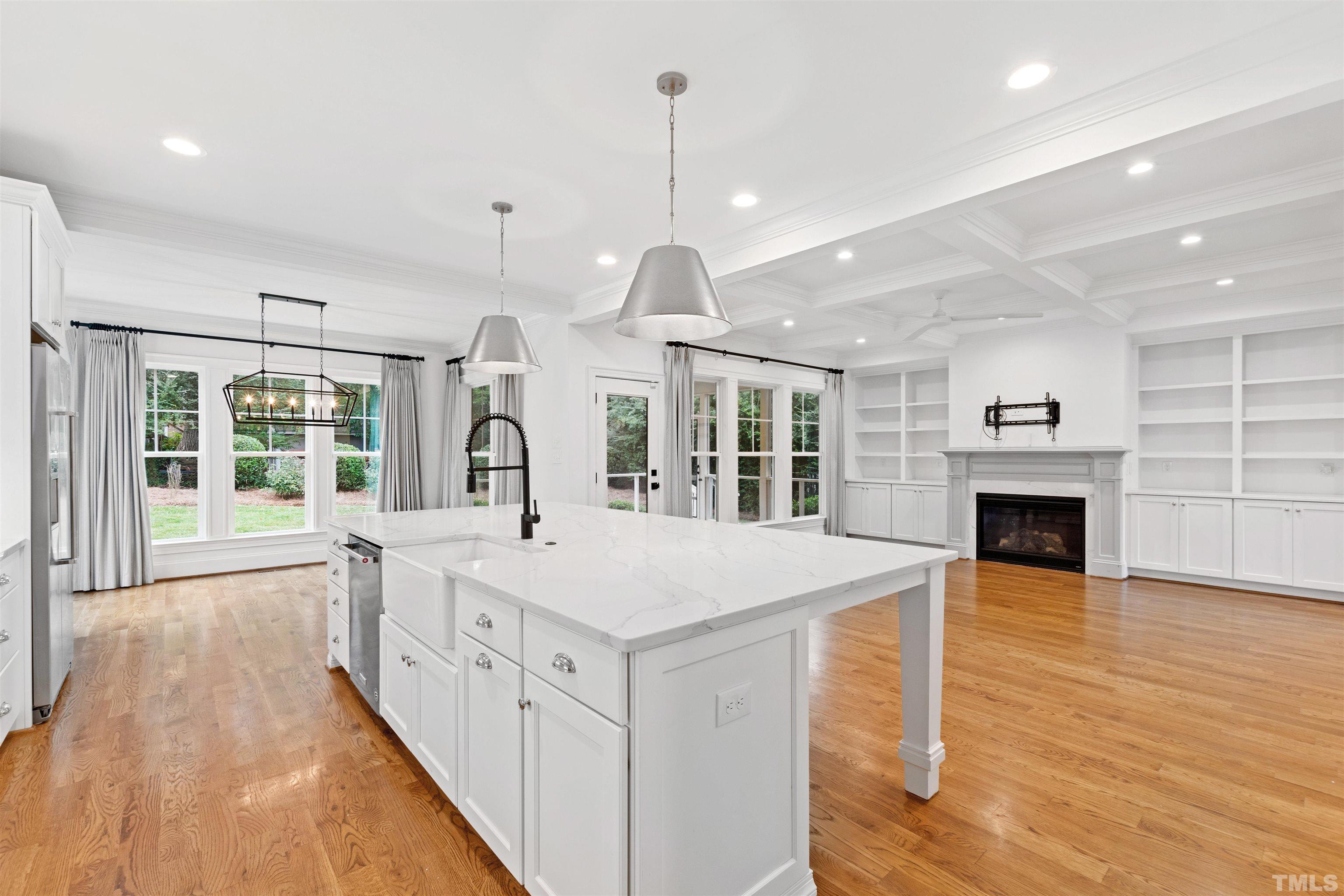 401 Latimer Road Raleigh, NC 27609 - Photo 8 of 45 a large white kitchen with a large window a oven and a chandelier
