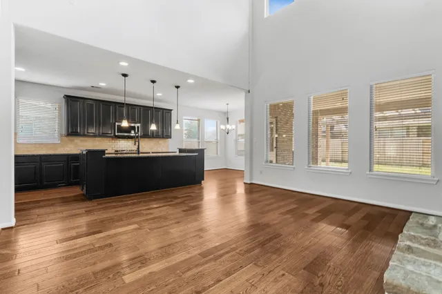 a view of kitchen with wooden floor and electronic appliances