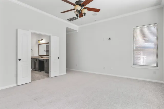 a bathroom with a tub a mirror and a shower