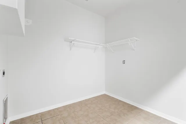 an empty room with windows and mirror