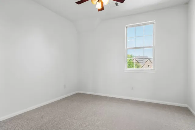 an empty room with a ceiling fan