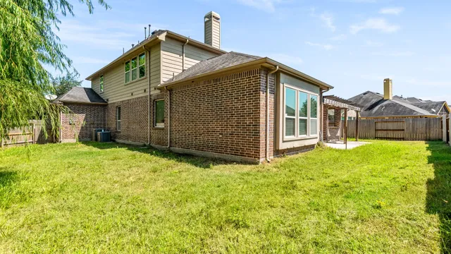 a view of a small yard with wooden fence