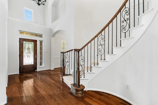 a view of entryway with wooden floor and stairs