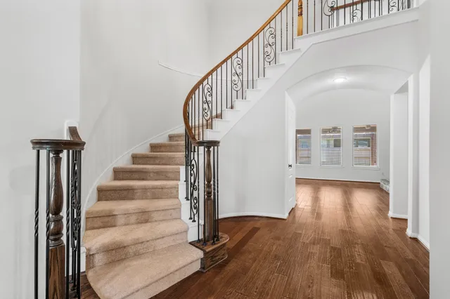 a view of entryway and hall with wooden floor