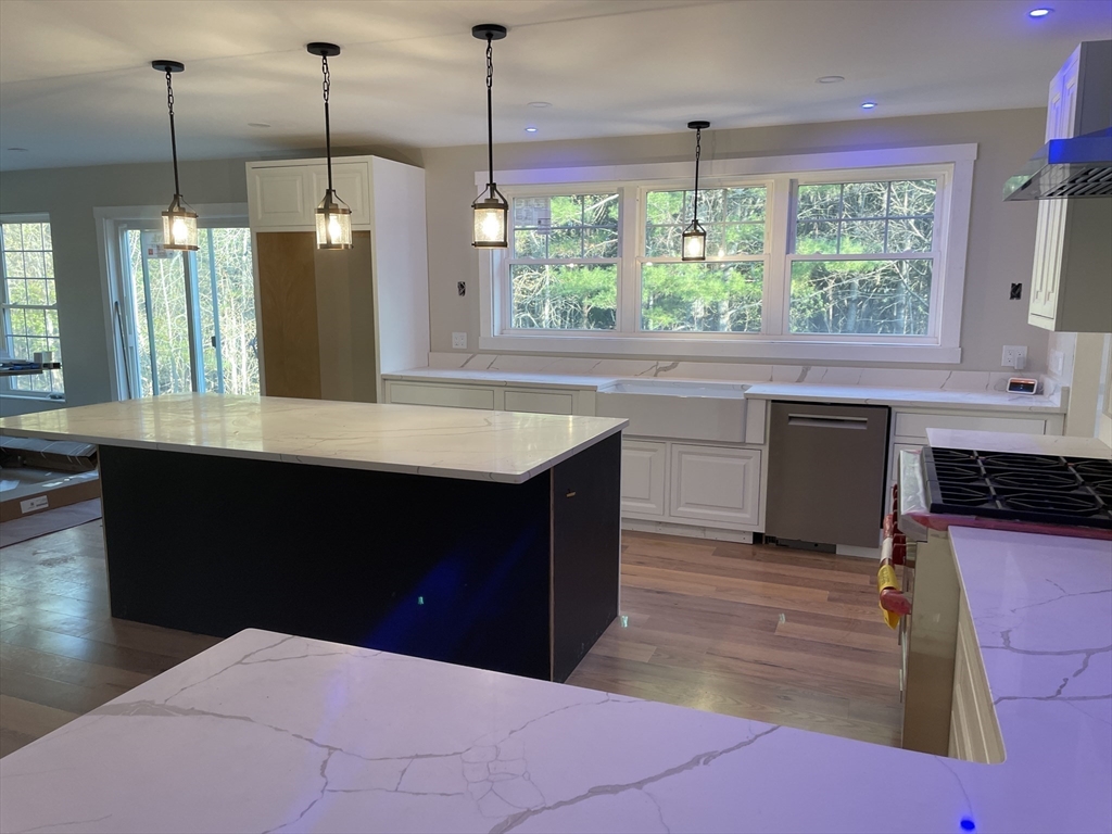 28 Marion Road Rochester, MA 02770 - Photo 4 of 23 a kitchen with kitchen island a counter top space appliances and a window