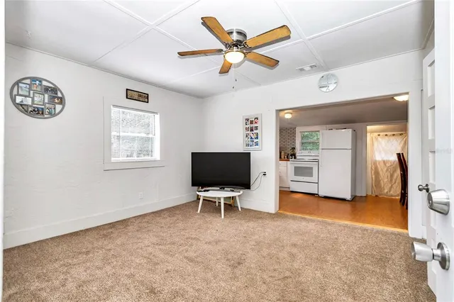 a kitchen with a refrigerator and white cabinets