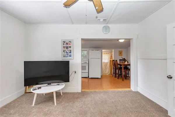 a kitchen with stainless steel appliances white cabinets and white appliances