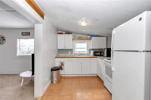 a view of kitchen with furniture and refrigerator
