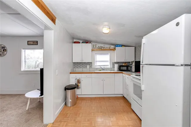 a view of kitchen with furniture and refrigerator