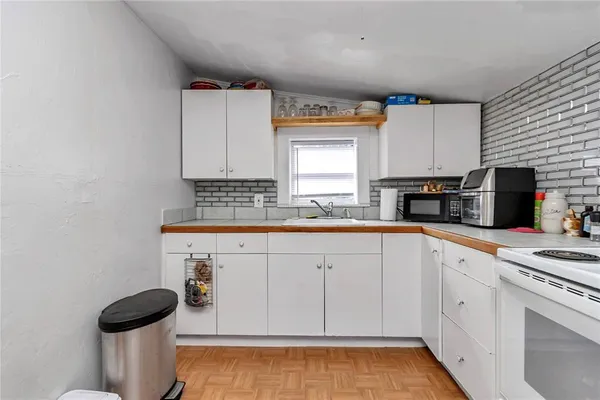 a view of a utility room with fridge and closet