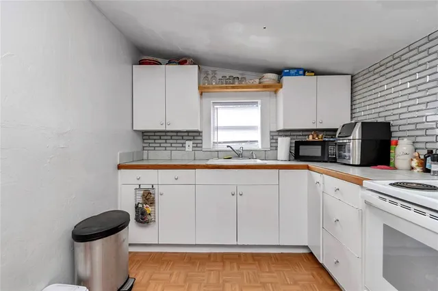 a view of a utility room with fridge and closet