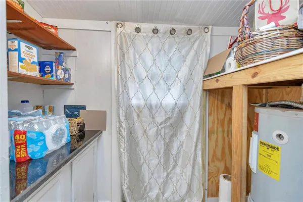 a bedroom with bed and a chandelier