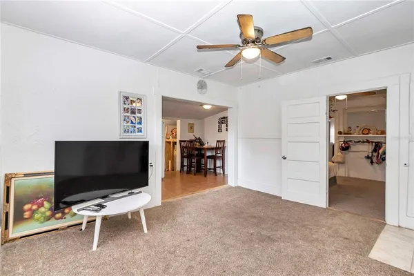 a view of a bedroom with baby crib and a window