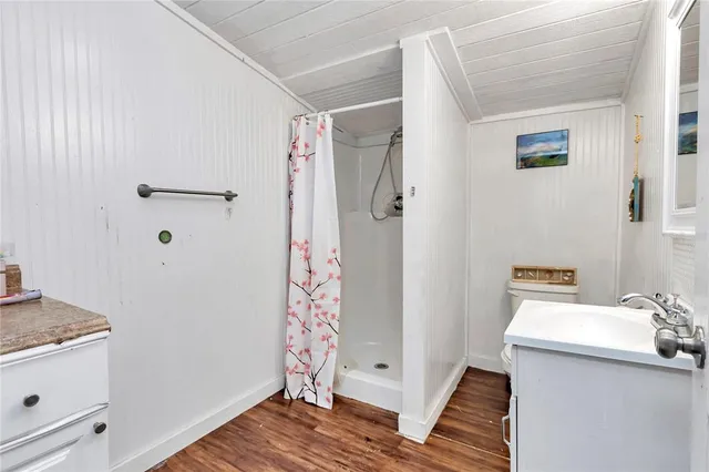 a spacious bedroom with a bed and a flat screen tv