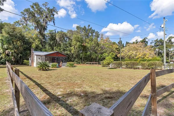 a room with stainless steel appliances kitchen island granite countertop furniture a stove a sink and a refrigerator