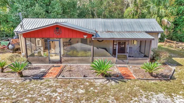 a view of small house with porch and furniture