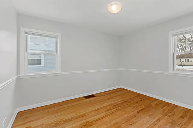 a view of a room with wooden floor and fan