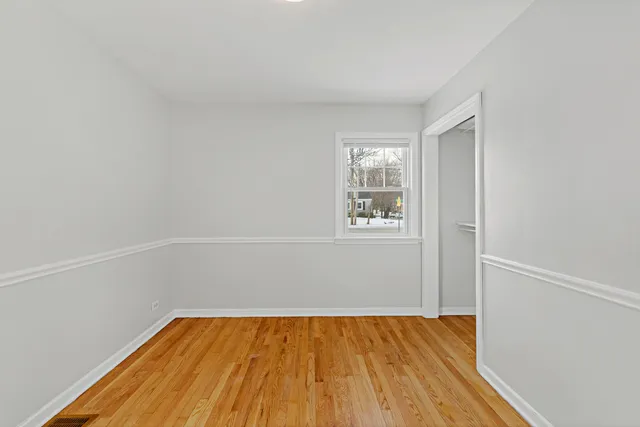 a view of a room with wooden floor and cabinet