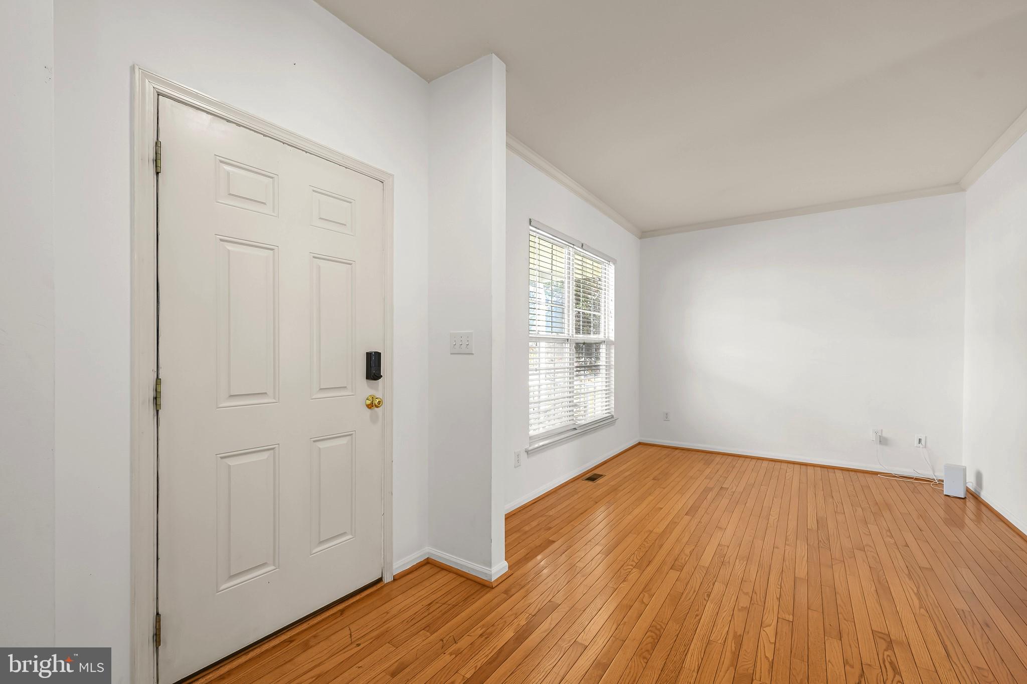 451 Carrington Drive Dover, DE 19904 - Photo 13 of 44 an empty room with wooden floor and windows