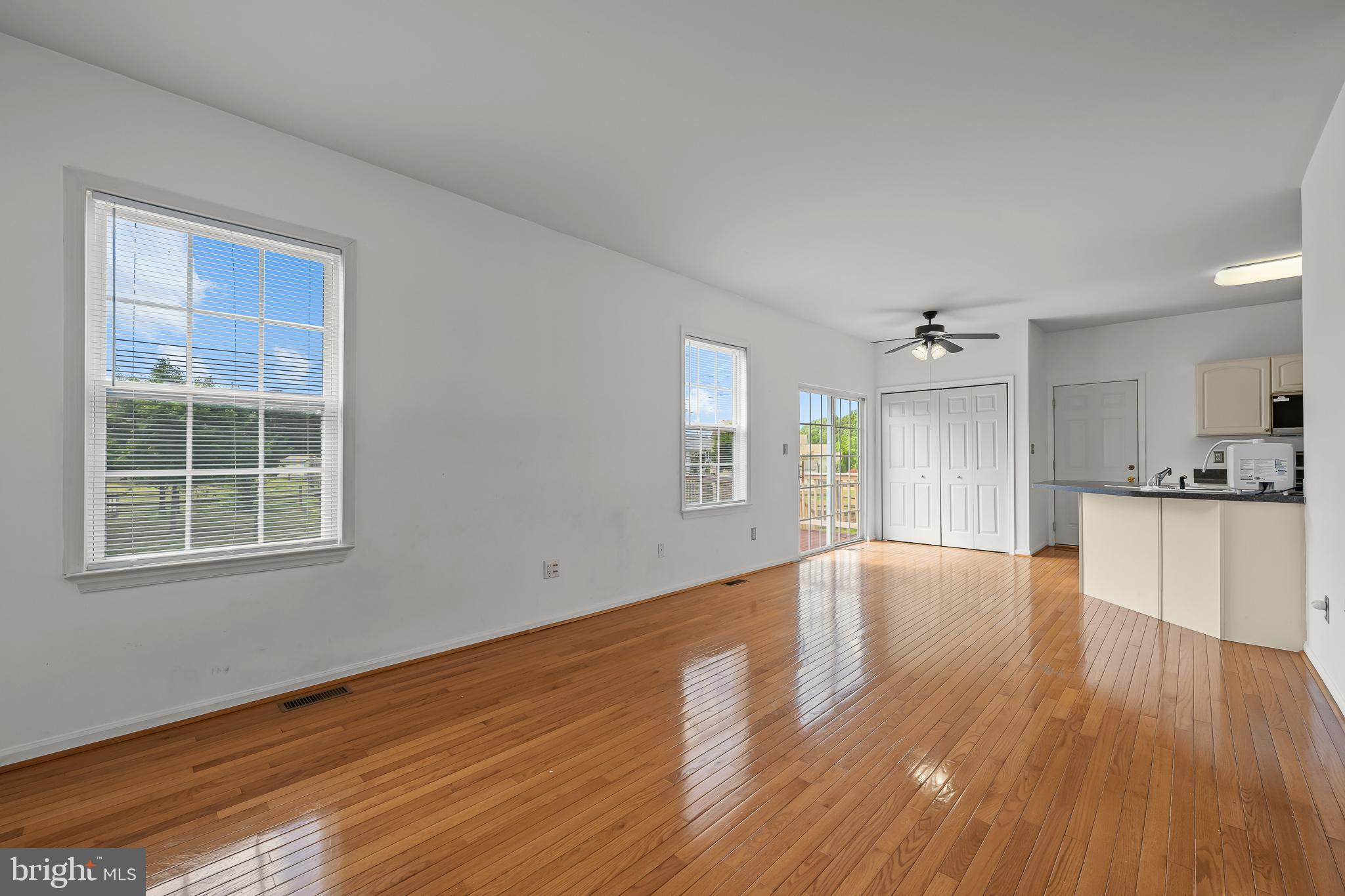 451 Carrington Drive Dover, DE 19904 - Photo 6 of 44 a view of an empty room with wooden floor and a window
