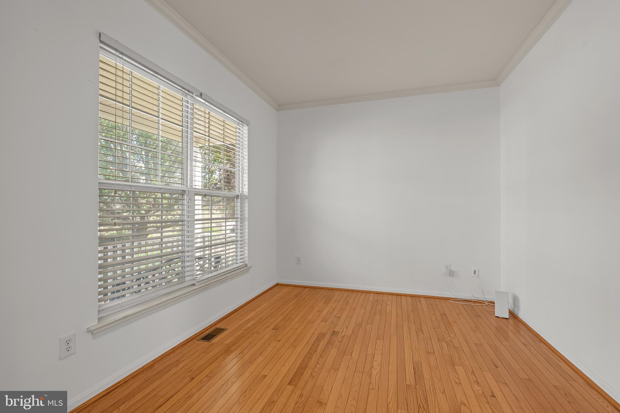 451 Carrington Drive Dover, DE 19904 - Photo 9 of 44 a view of an empty room with wooden floor and a window