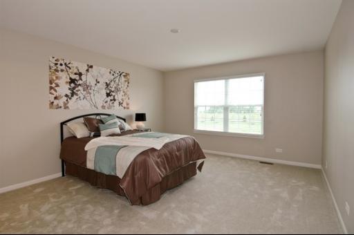 925 Oak Ridge Boulevard Elgin, IL 60120 - Photo 7 of 10 a bedroom with a bed and a window