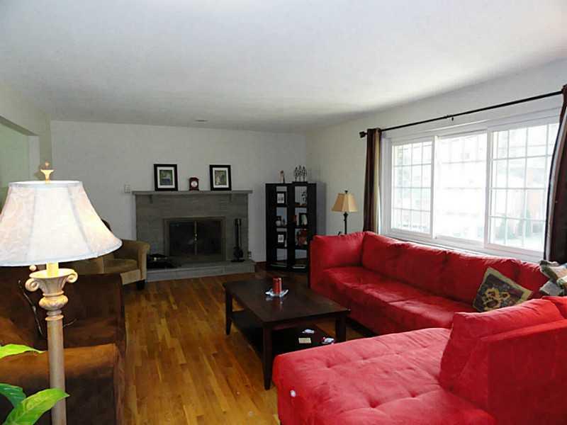 104 Kingsdale Road Churchill, PA 15221 - Photo 3 of 24 Living Room. The stone wood-burning fireplace has a gas starter.