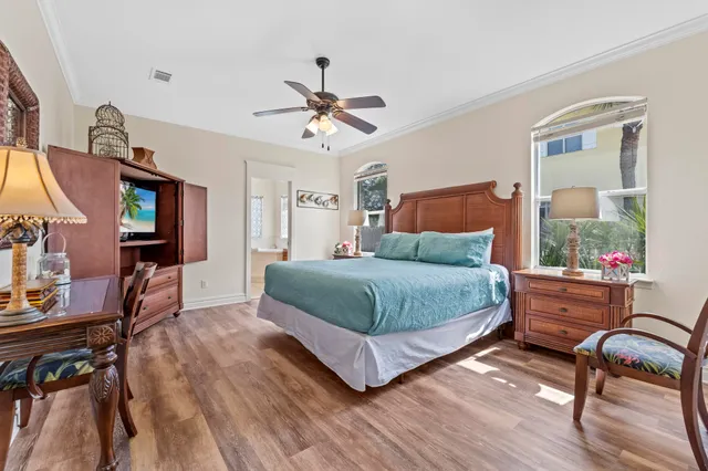 a bedroom with a bed a chair and a chandelier