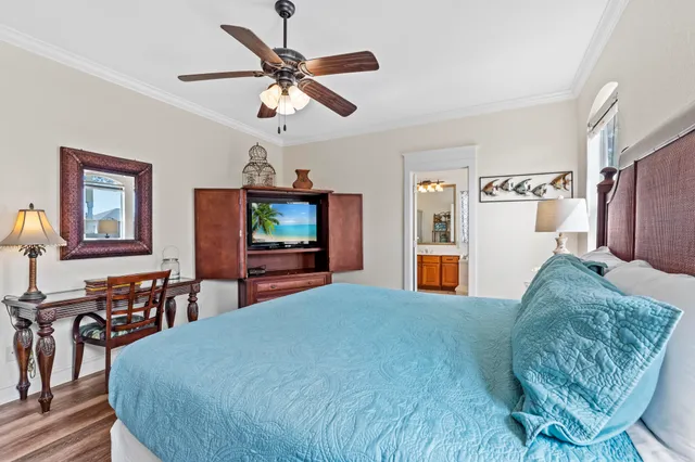 a bedroom with a bed and a chandelier