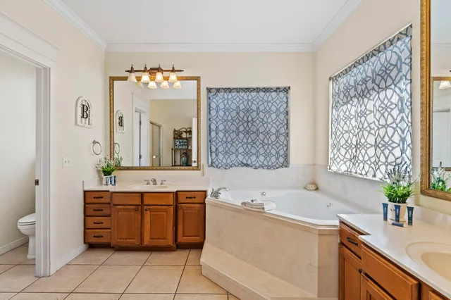 a large bathroom with a tub sink and mirror