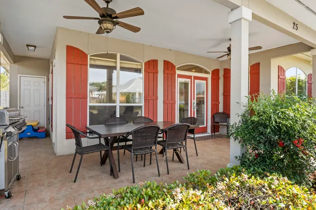 a view of a dinning table and chairs in patio of the house