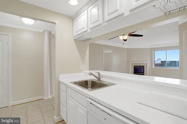 a sign board with buildings in the background