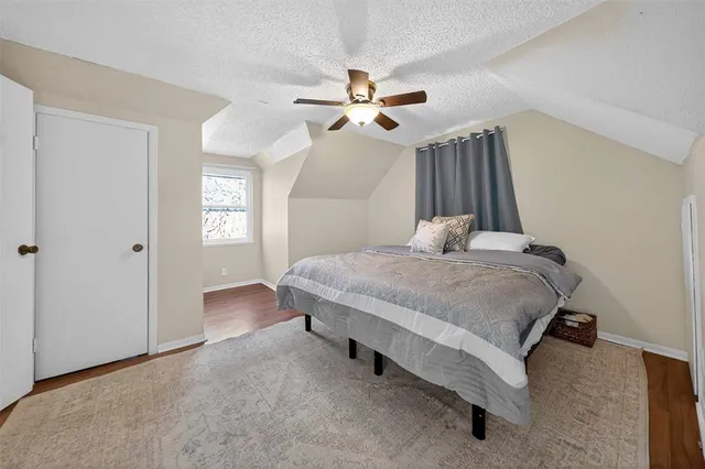 a bedroom with a bed dresser and a window