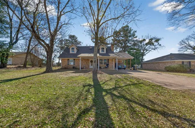 a view of house with yard