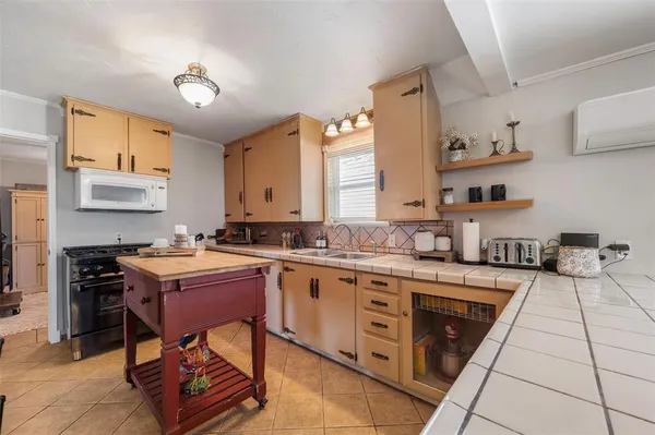 a kitchen with a stove a sink and a refrigerator