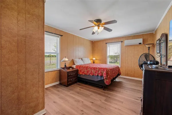 a bedroom with a bed dresser and a window