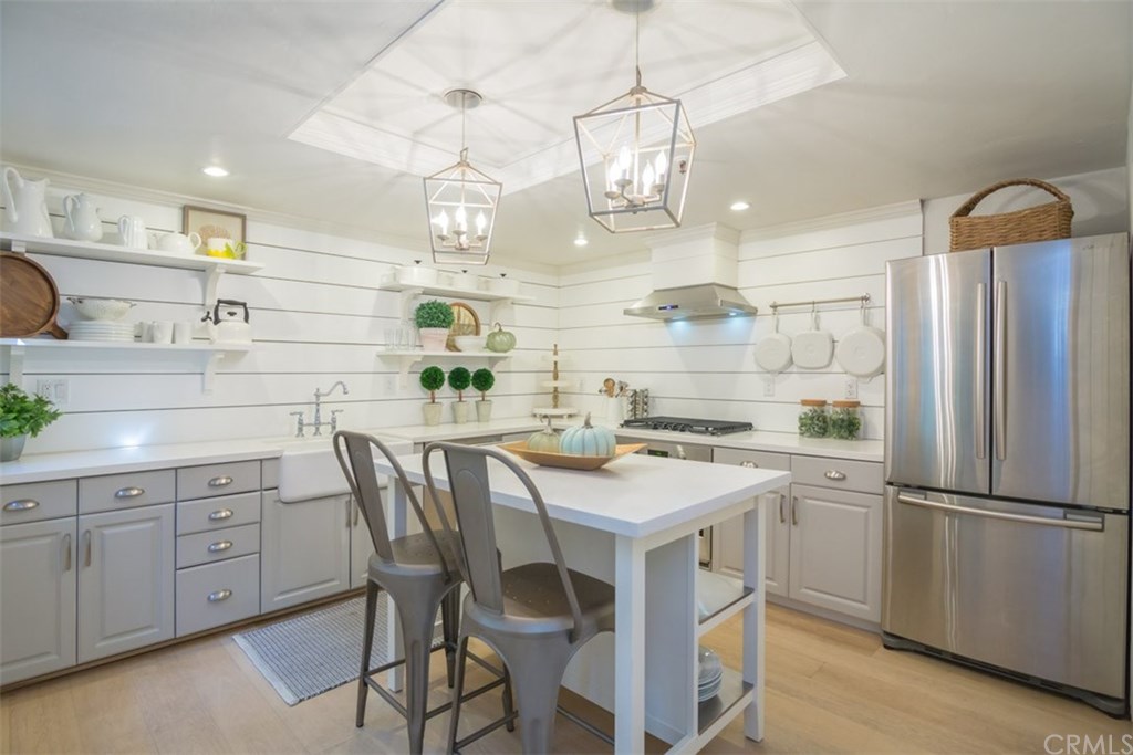a kitchen with a sink a center island and cabinets