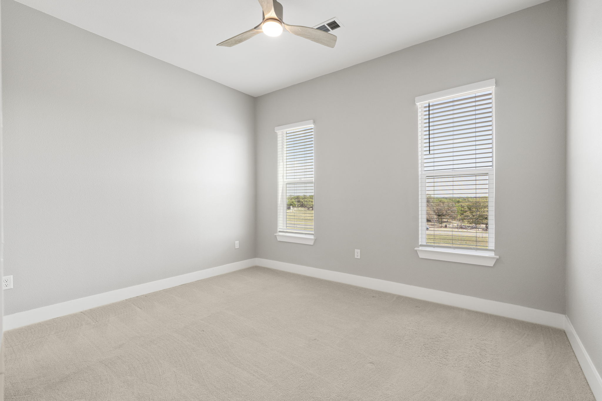 4501 Jackson Avenue, Unit 5205 Austin, TX 78731 - Photo 12 of 40 Empty room with light carpet and ceiling fan