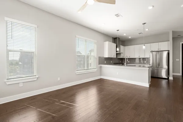 a view of kitchen with kitchen island and stainless steel appliances