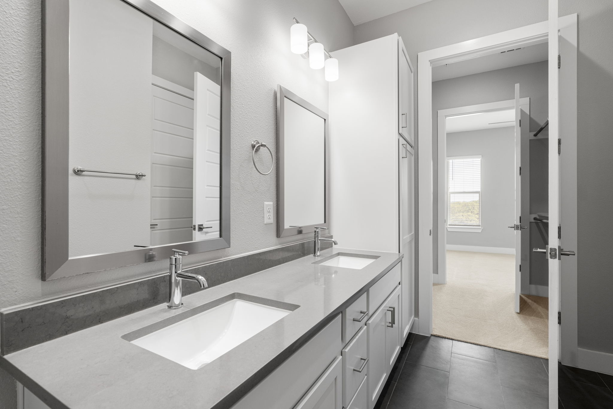 4501 Jackson Avenue, Unit 5205 Austin, TX 78731 - Photo 16 of 40 Bathroom featuring double vanity, dark carpet, and dark tile patterned floors