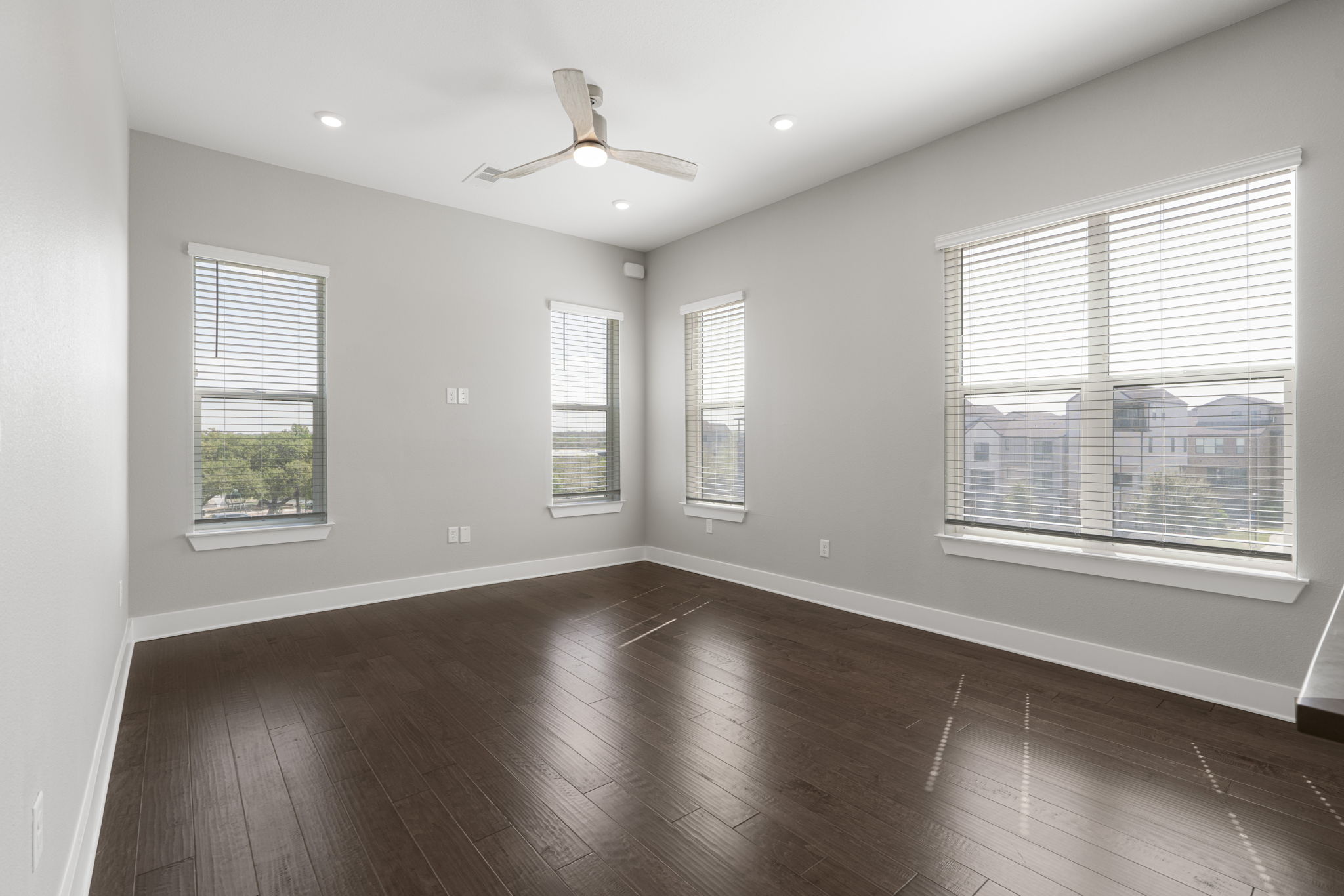 4501 Jackson Avenue, Unit 5205 Austin, TX 78731 - Photo 2 of 40 Empty room featuring ceiling fan, dark wood-style flooring, and recessed lighting